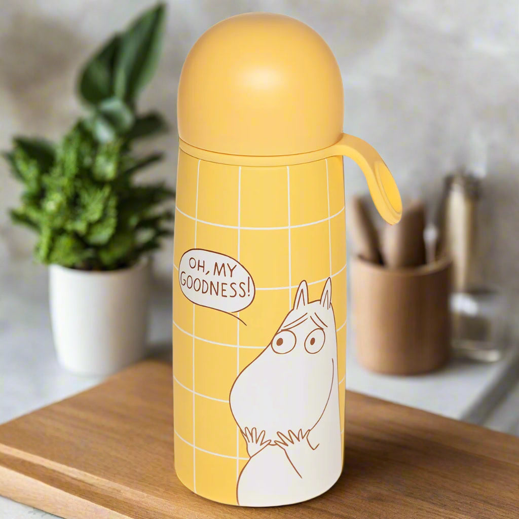 Yellow water bottle with moomin character and &#39;Oh, My Goodness!&#39; text on a white background